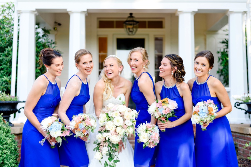 bride and bridesmaids laughing at each other 