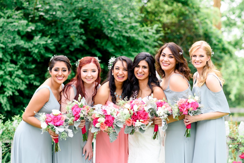 bridesmaids leaning in and smiling at the camera