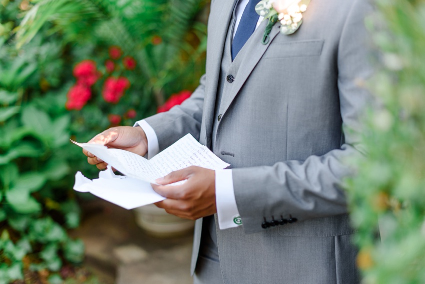 groom reading letter from his bride before the wedding