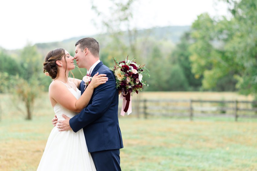 bride and groom kissing in the field at sorella farms 
