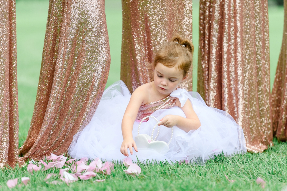 flower girl playing with rose petals