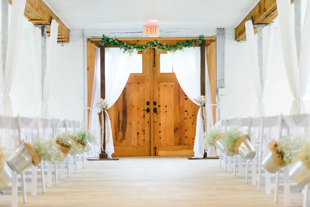 white barn indoor wedding ceremony