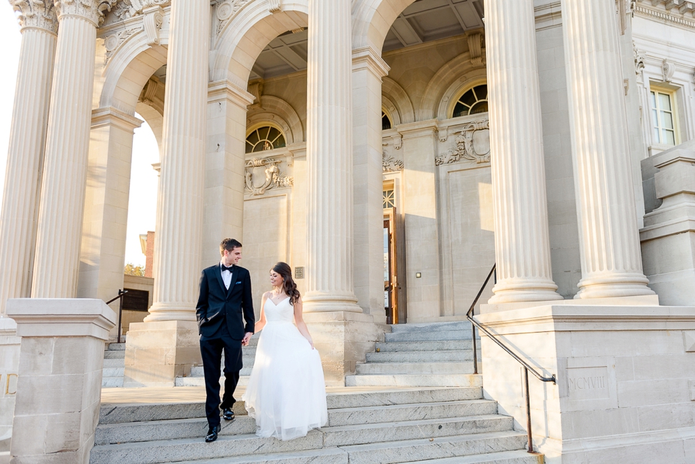 newlyweds walking down the steps at their castle wedding