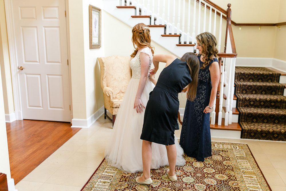 bride getting in her dress