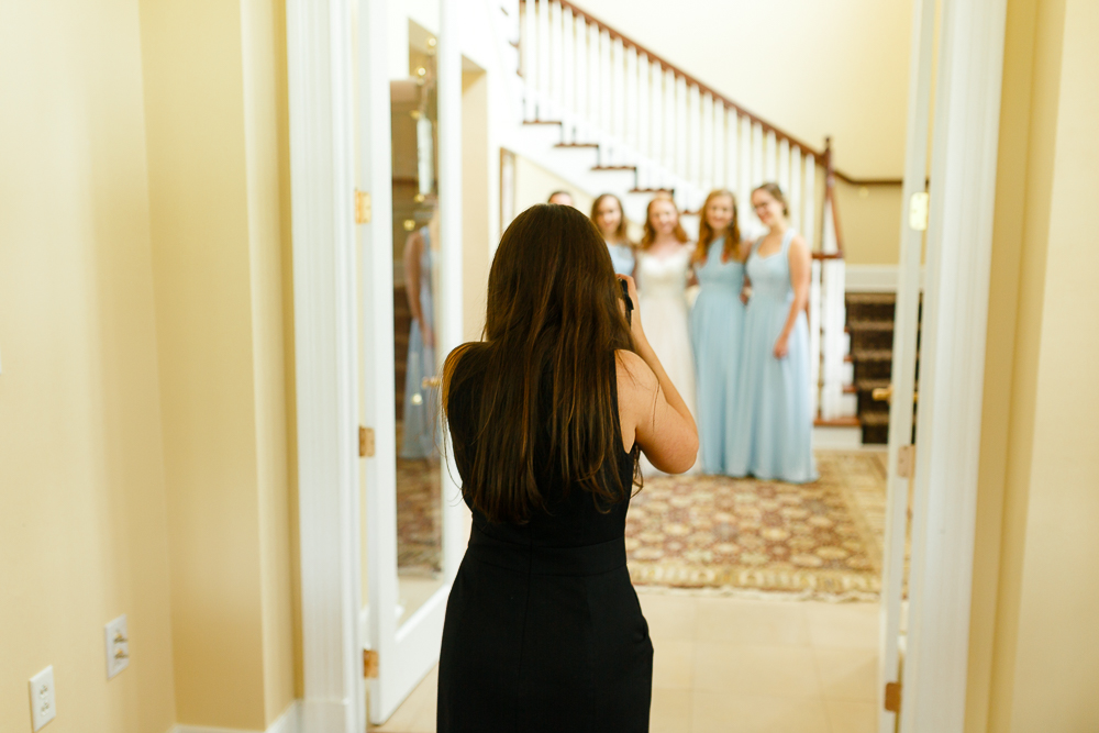 photographer taking bridesmaids pictures