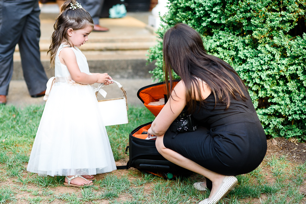 flower girl helping photographer