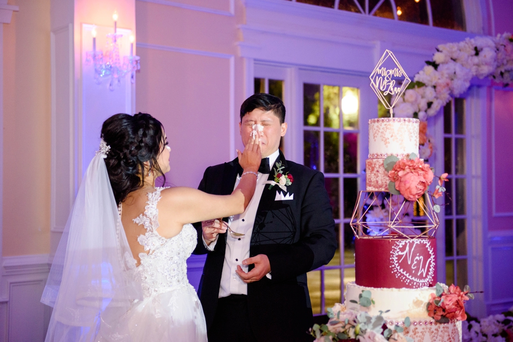 bride smashing cake in groom's face