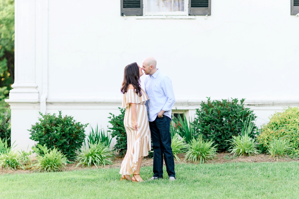 couple kissing for enaggement photos at historic rosemont manor