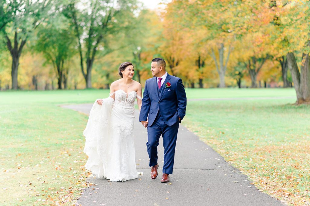 bride and groom walking at their Woodlands at Algonkian wedding