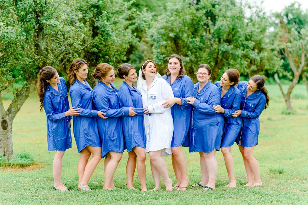 bridesmaids wearing blue robes and smiling