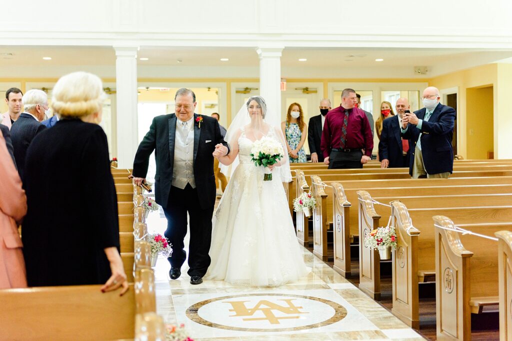 bride walking down the aisle in catholic church
