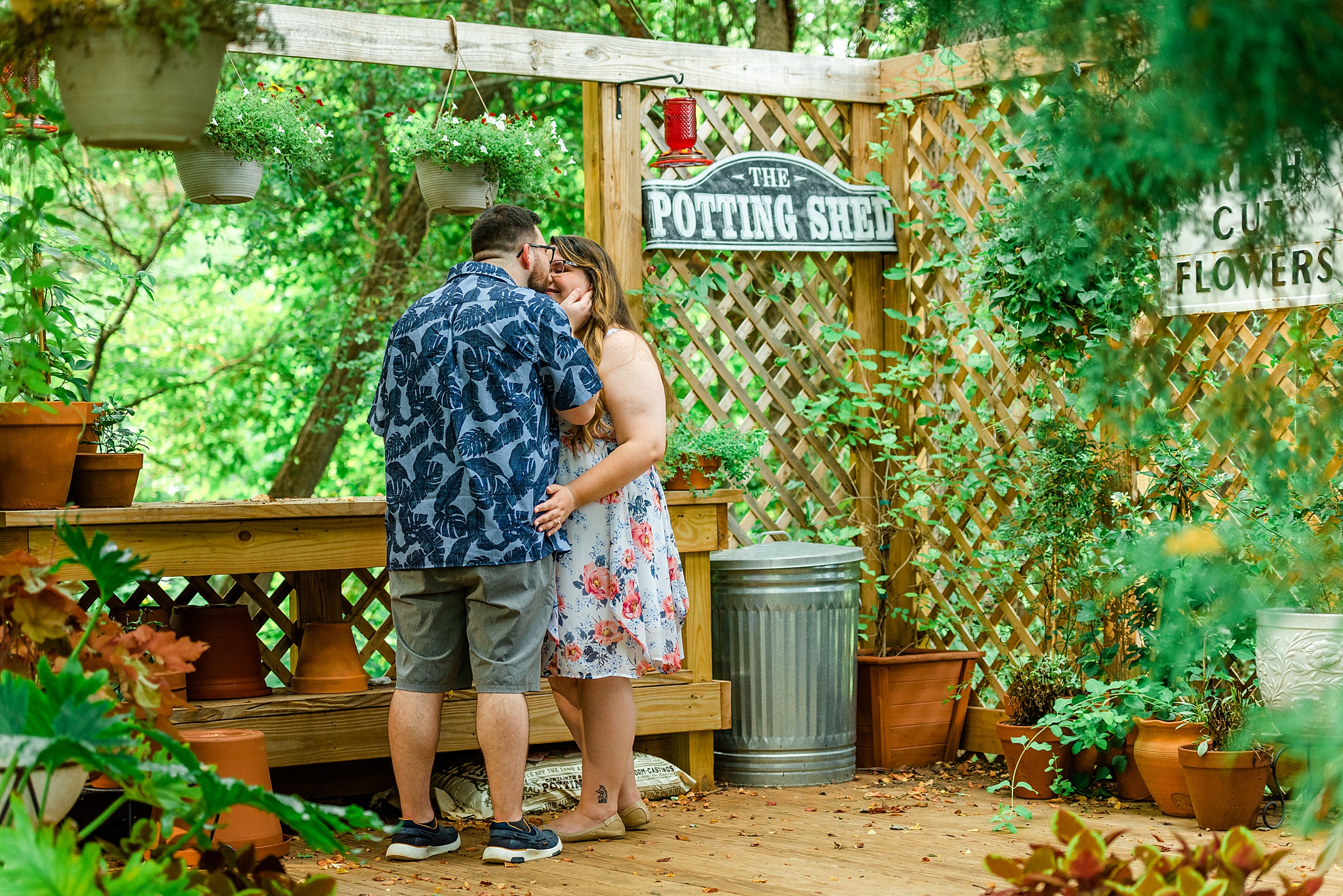 summer engagement picture at local greenhouse