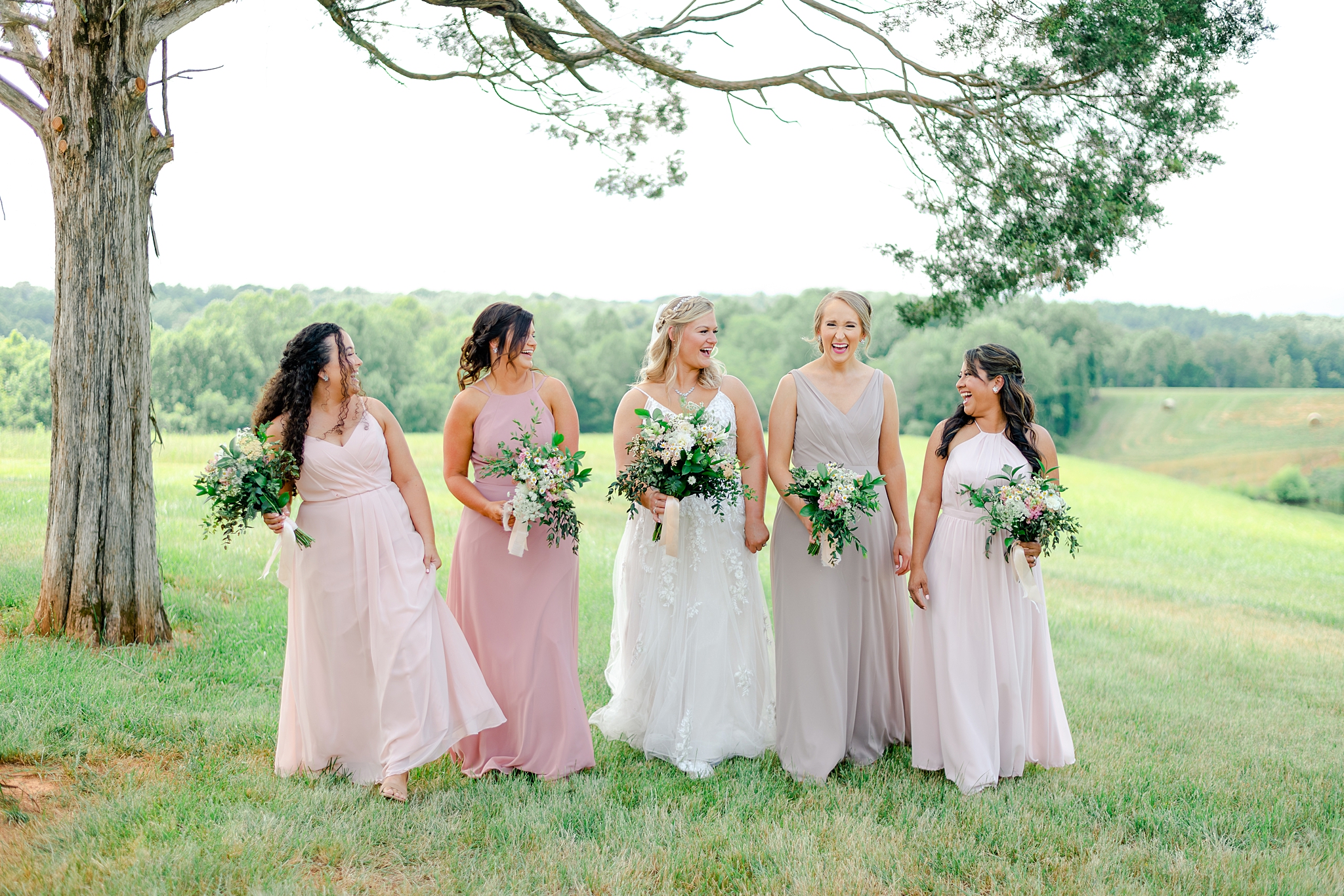 bridesmaids walking at Cedar Oaks Farm