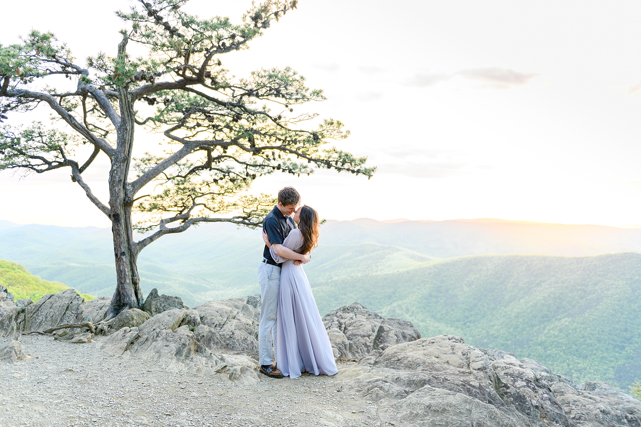 Lovebirds in an embrace at Ravens Roost Overlook, commemorating their engagement with a timeless photo.