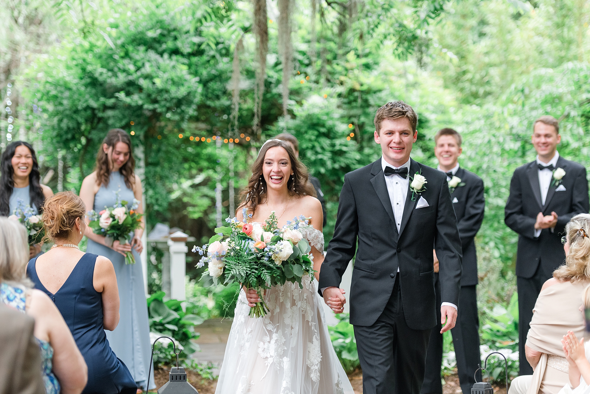 newlyweds walking down the aisle after their outdoor cermeony