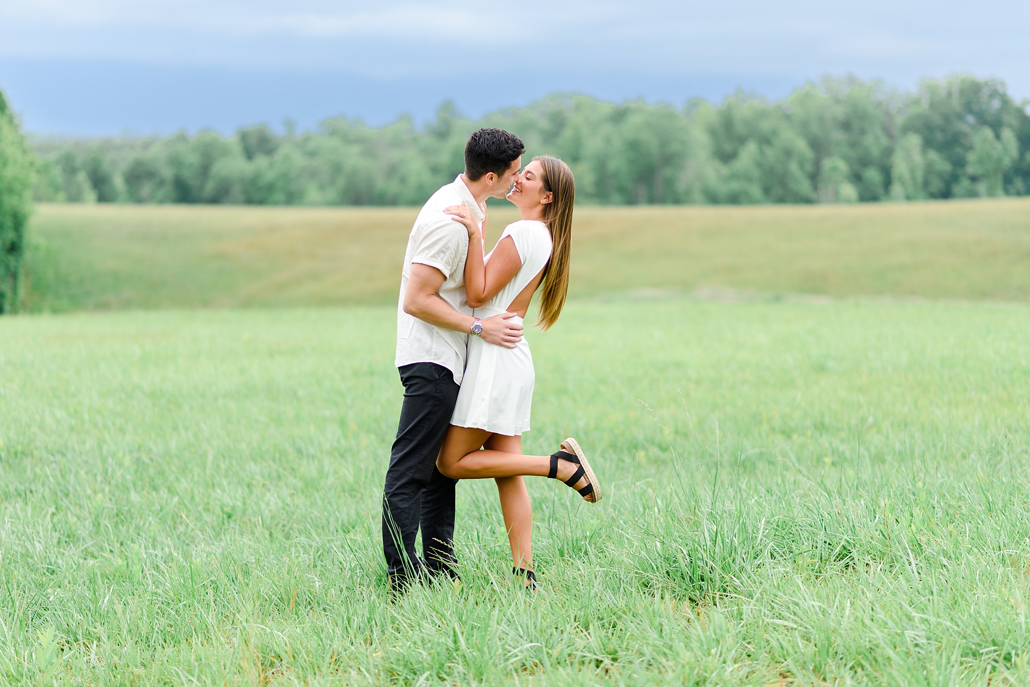 Bride and groom kissing for engagement photos at Cedar Oaks Farm in Bedford, VA