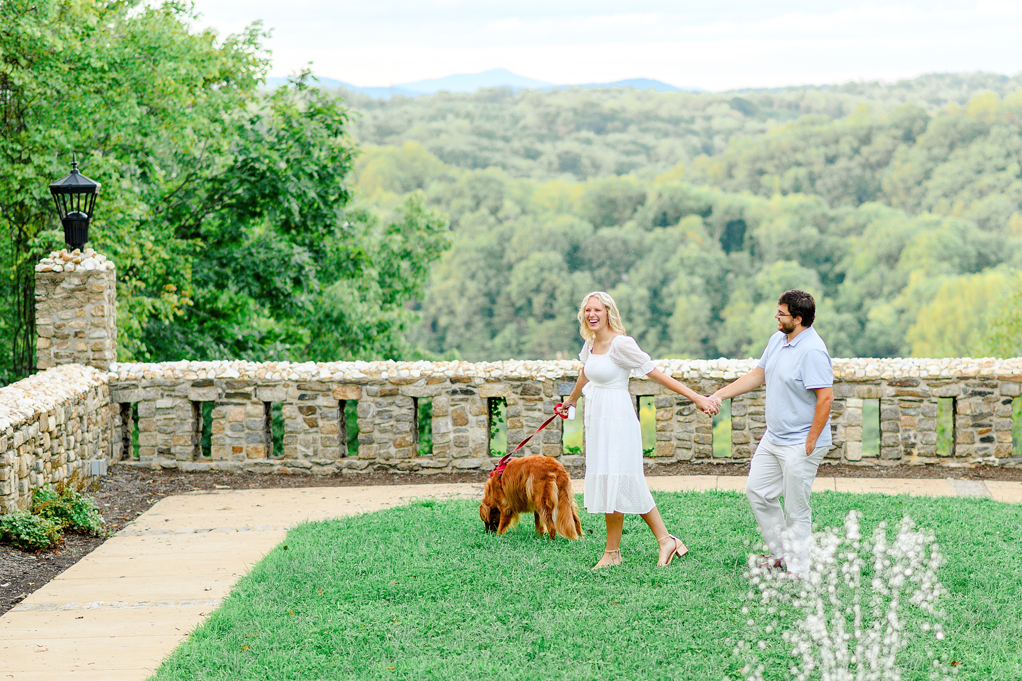 couple taking photos with dog