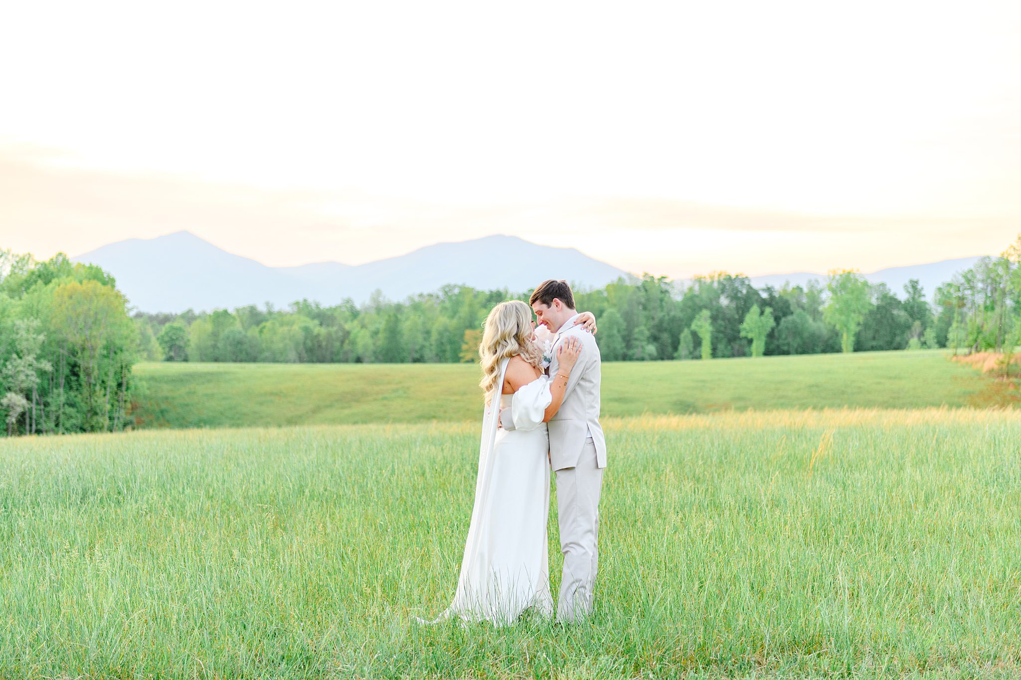 bride and groom taking photos in the field