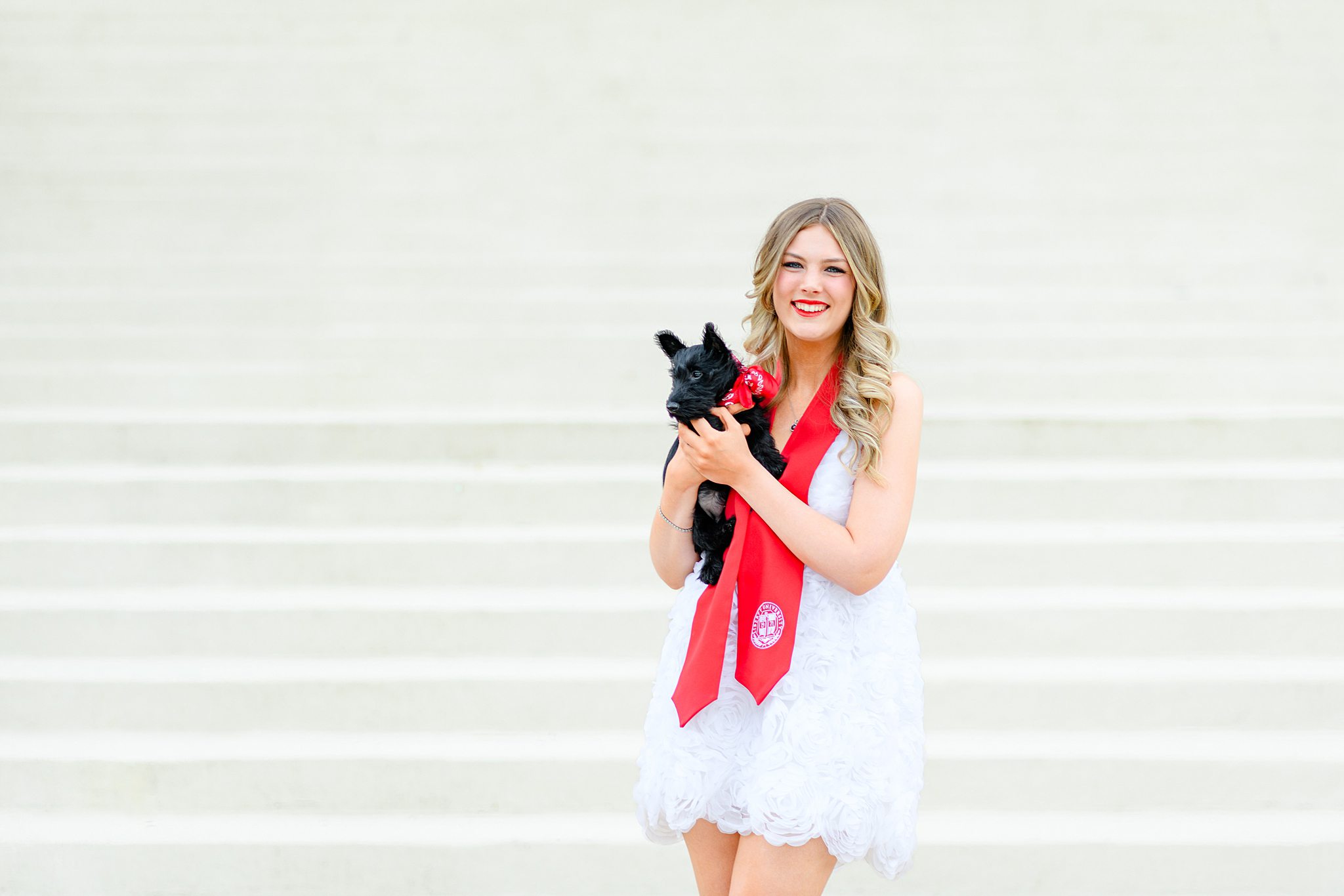 graduate taking photos with dog
