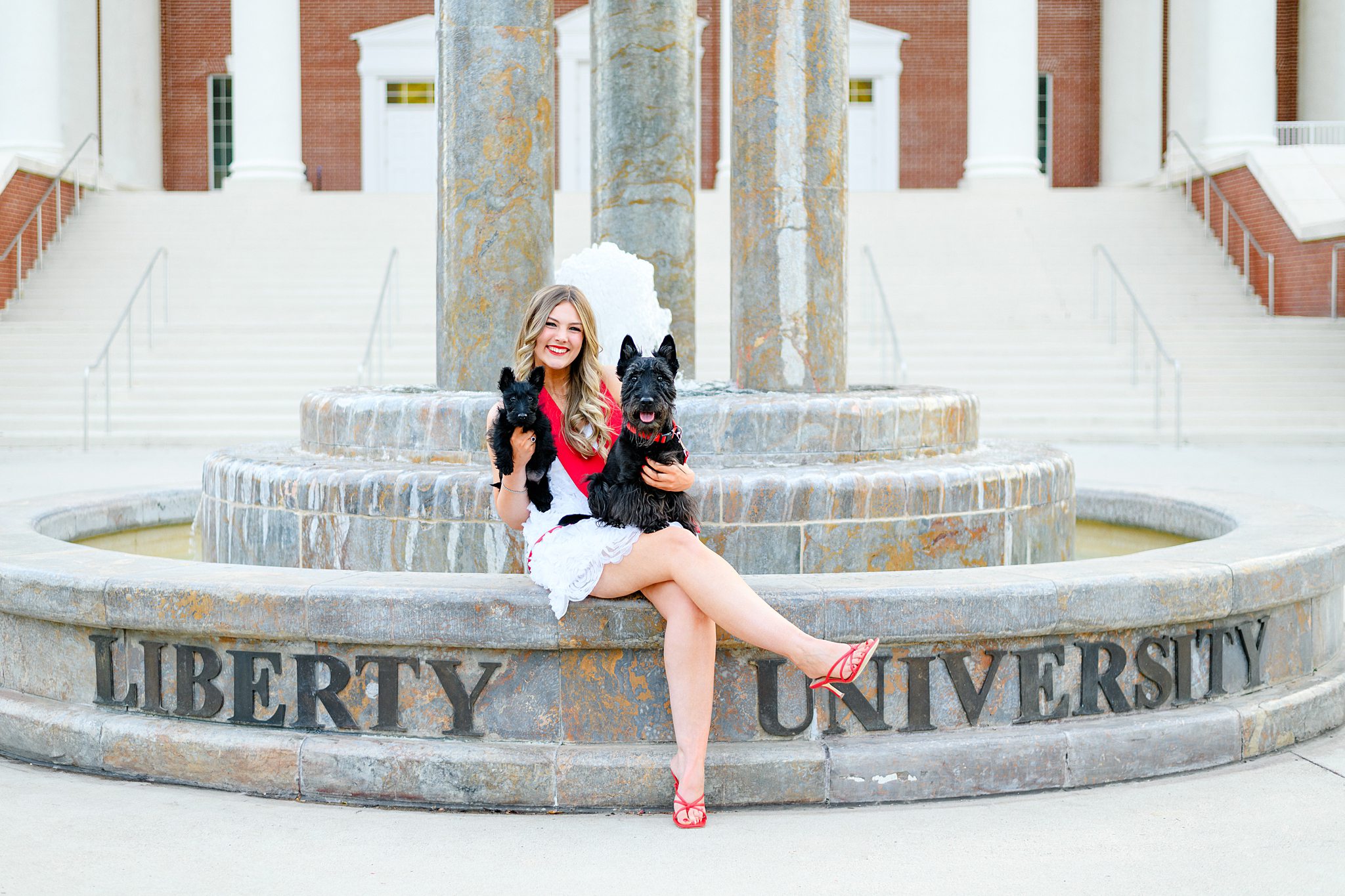 grad holding dogs for photos