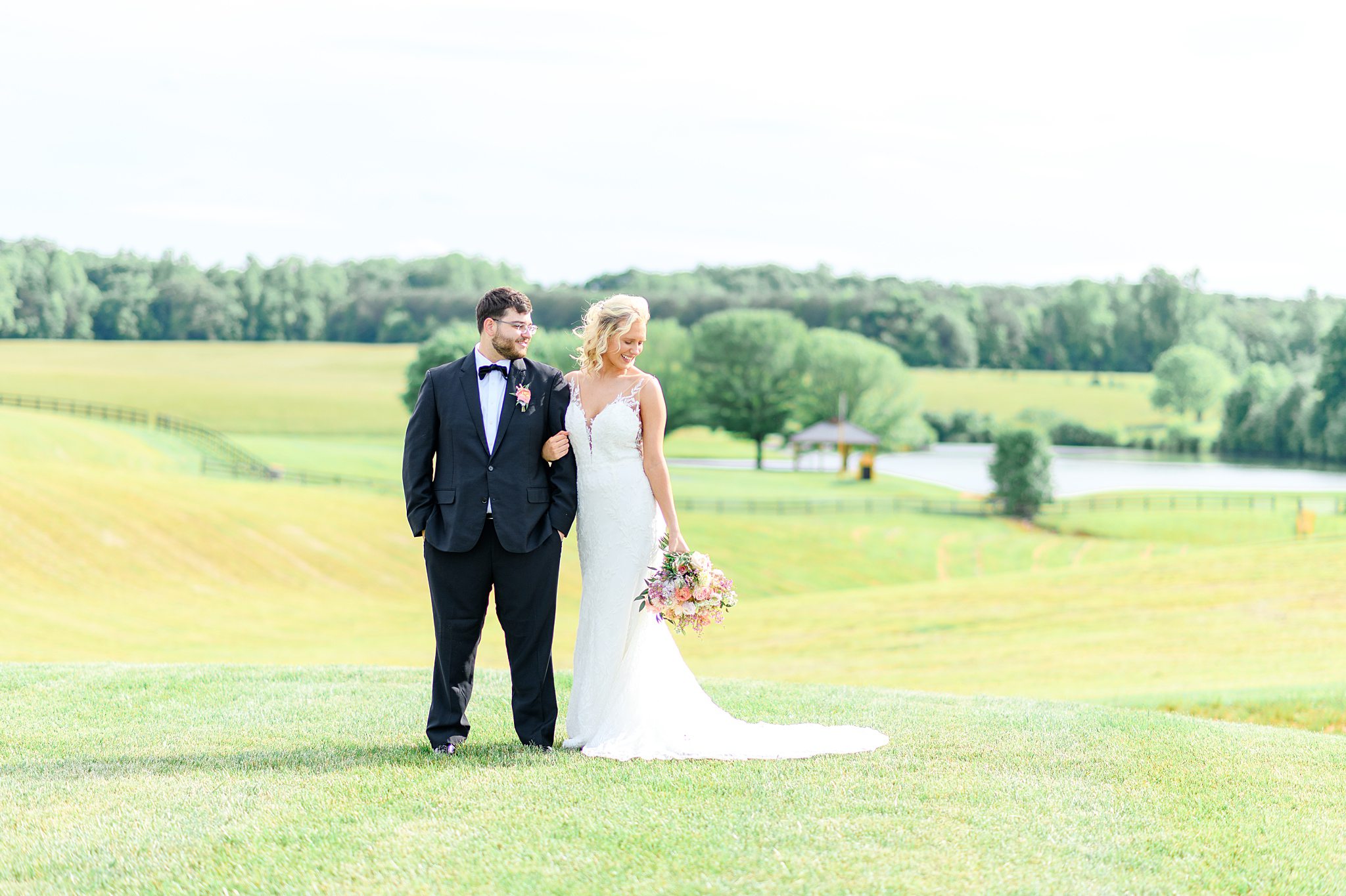 Romantic portrait of couple walking through garden path at Spring Grove