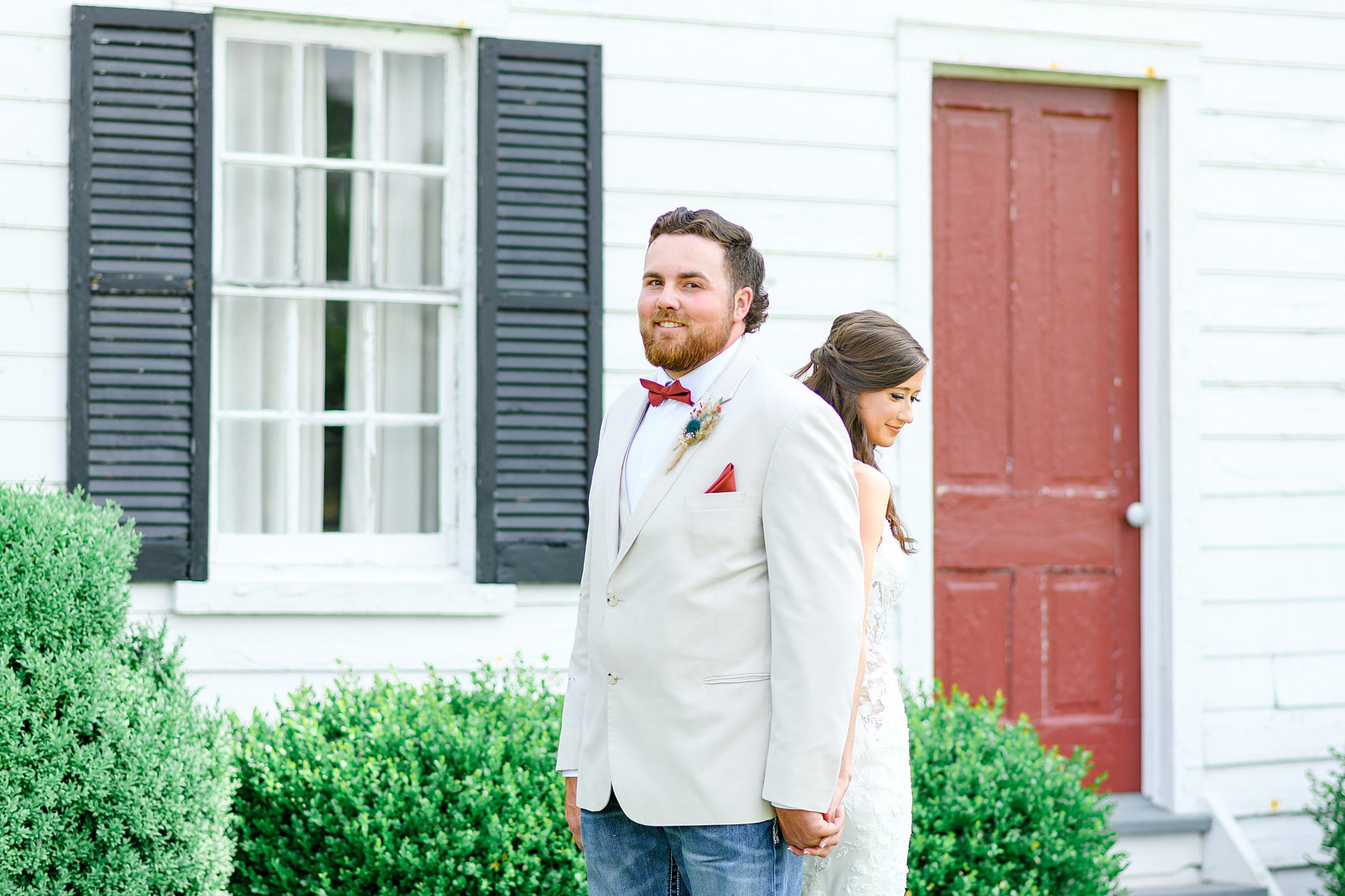 Groom during first touch no peek moment with bride
