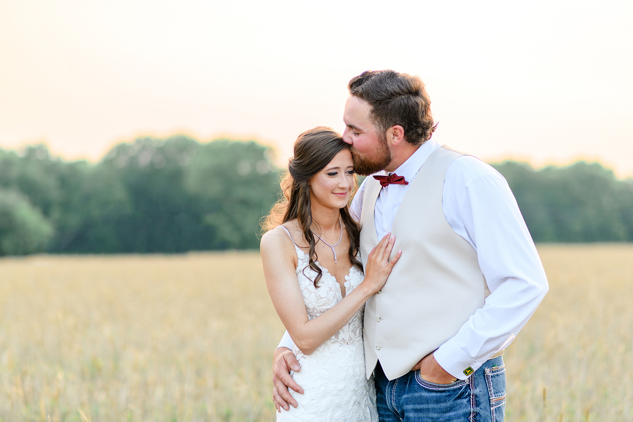 grooms kisses bride on temple during sunset photos
