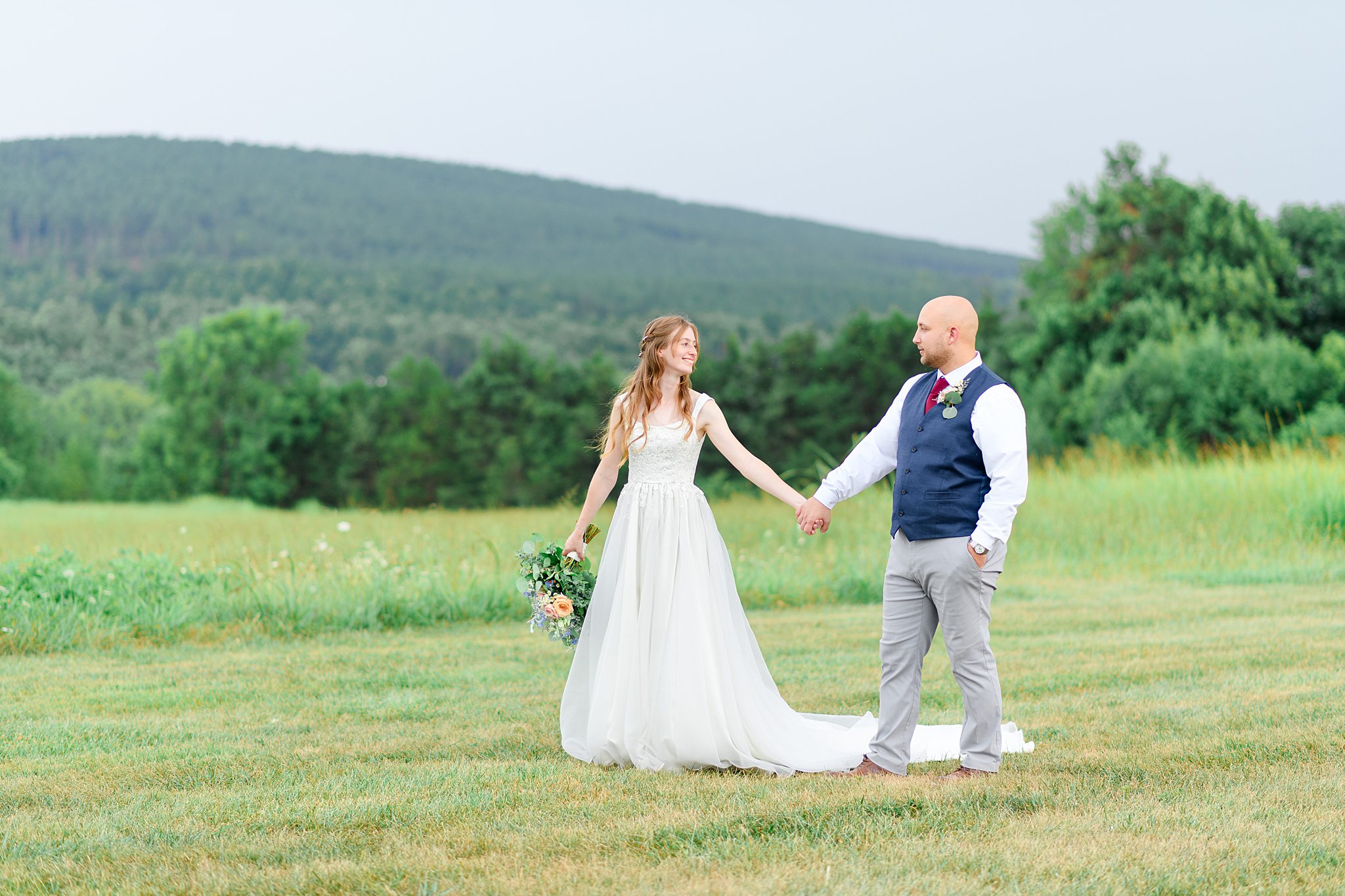 Couple posing near field at Sorella Farms