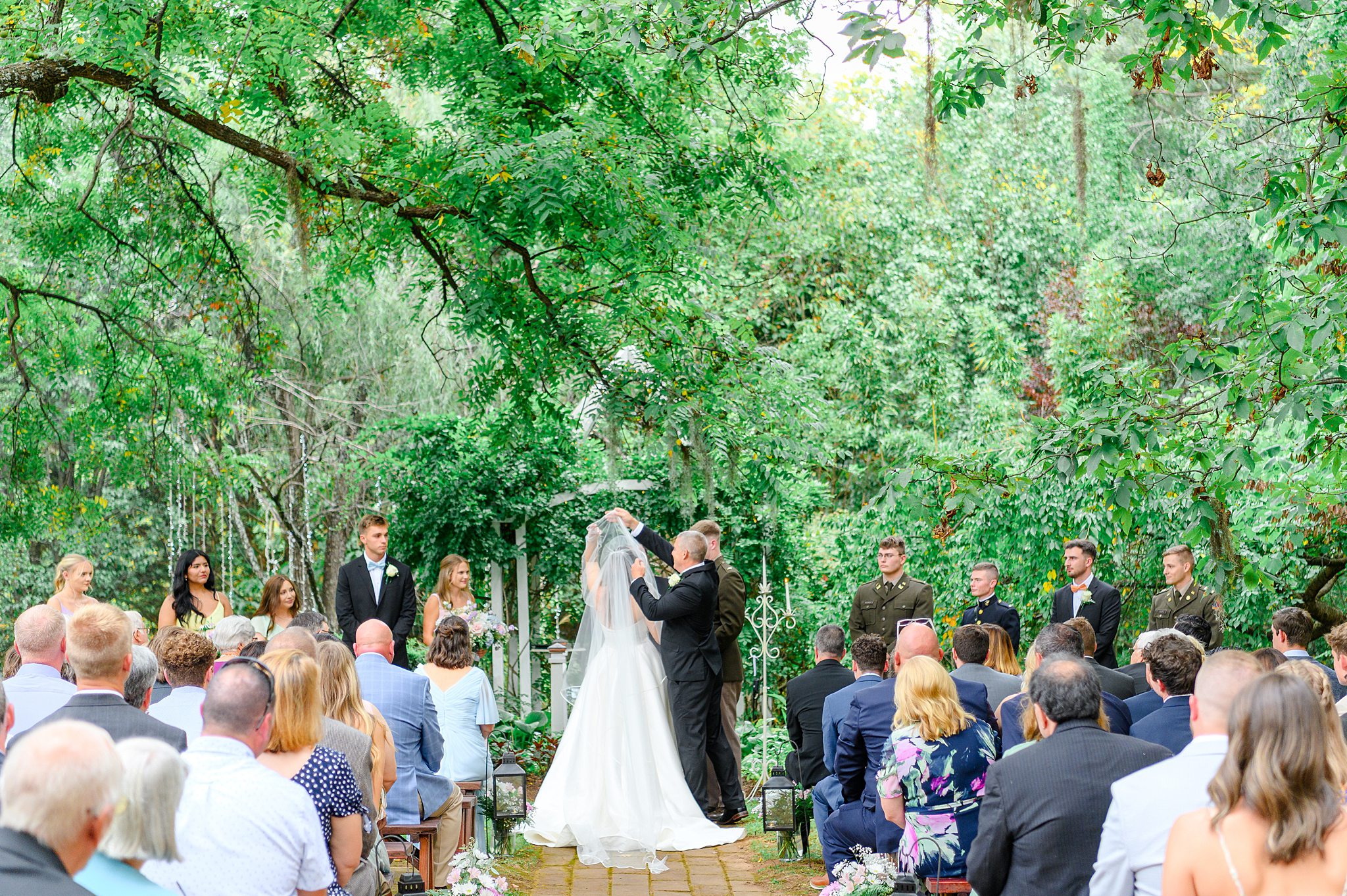 dad lifting veil off of bride's face