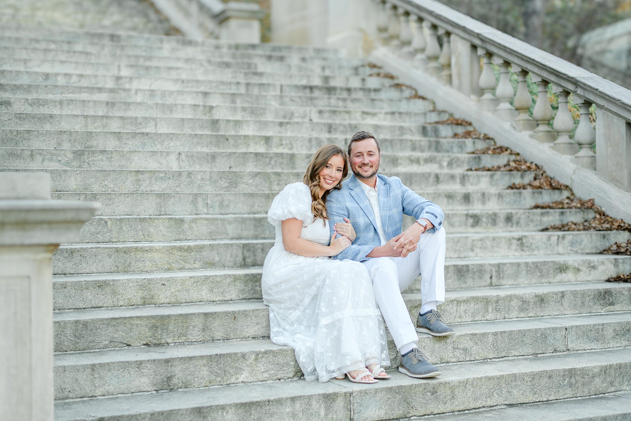 Couple sitting down at Monument Terrace steps downtown Lynchburg