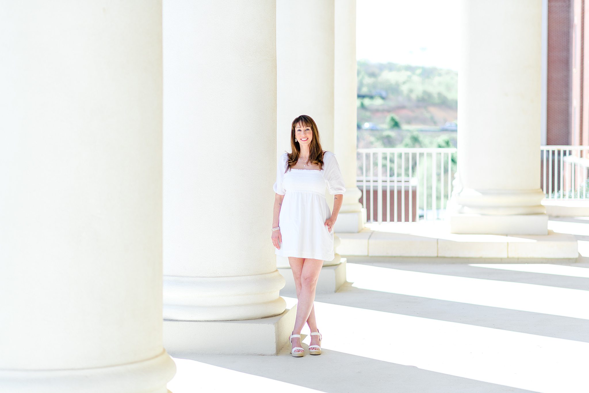 History PhD grad taking photos in front of Luberty University