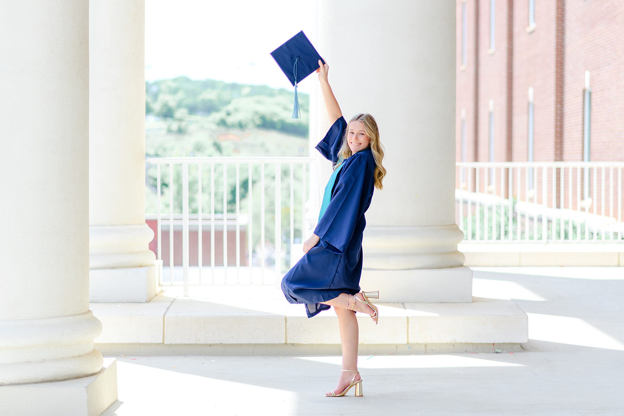 Hannah smiling in cap and gown during LUOA graduation photos at Liberty University