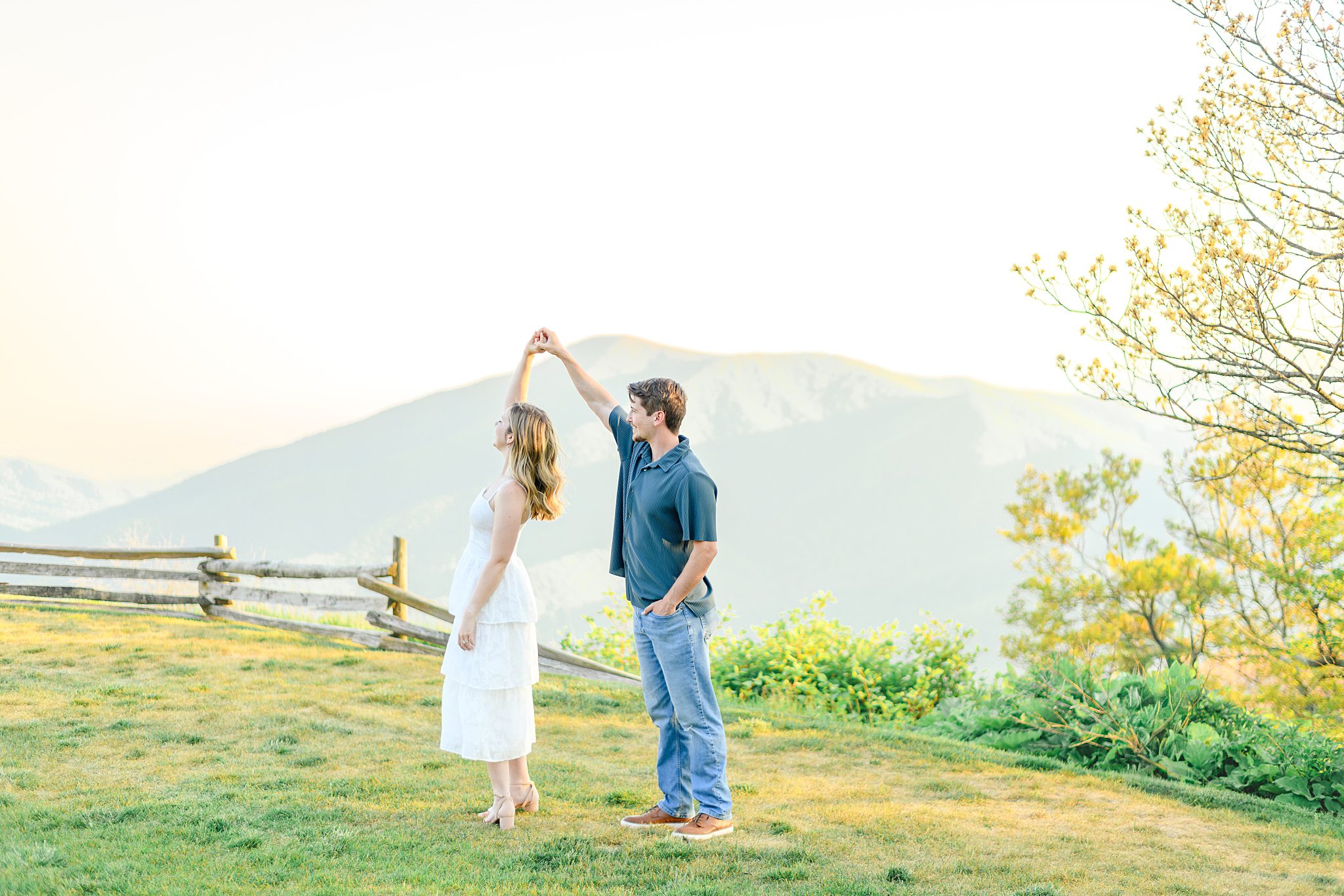Bride-to-be twirling during Ravens Roost engagement pictures with dreamy Blue Ridge Mountain scenery