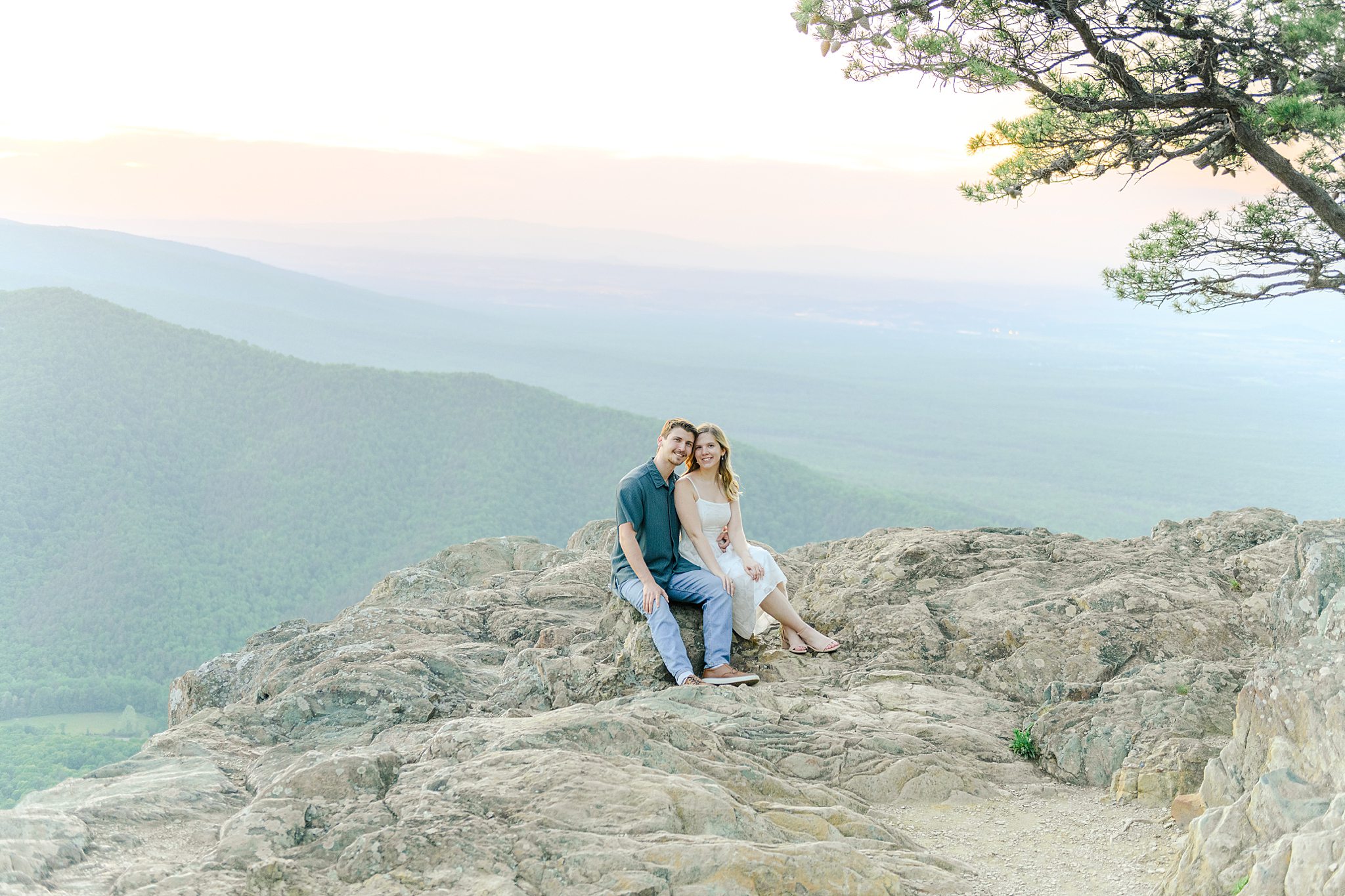Engaged couple cuddling together during romantic Ravens Roost engagement pictures in Virginia