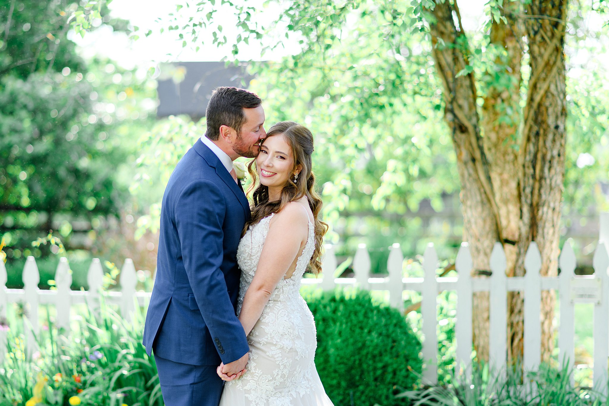 groom kissing bride on forehead