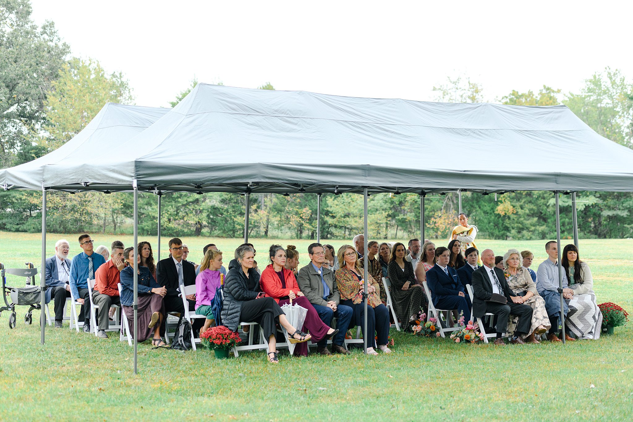 guests waiting for bride under tent